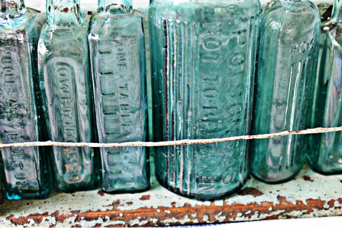 vintage poison bottles on shelf